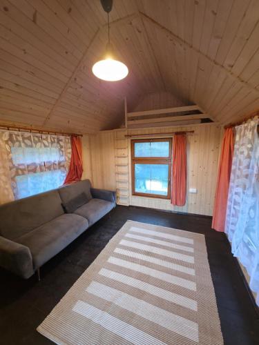 a living room with a couch and a window at U Richtára in Klokoč