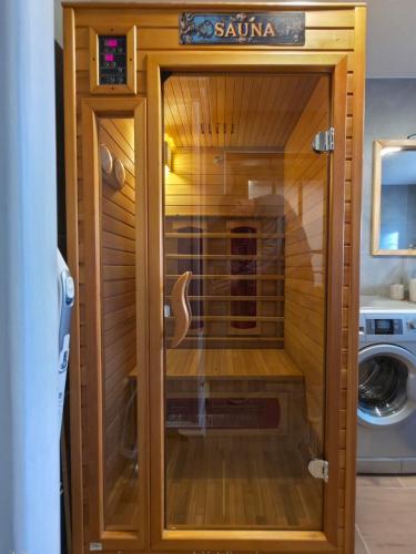 a glass door of a sauna in a bathroom at U Richtára in Klokoč