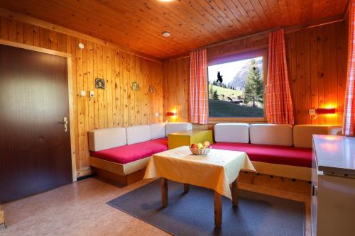 a room with a couch and a table and a window at Ferienbungalows MOHR in Sankt Jakob in Defereggen