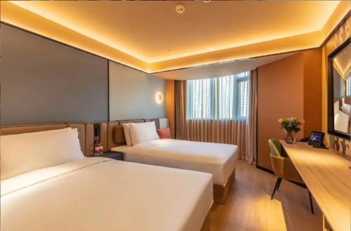 Ένα ή περισσότερα κρεβάτια σε δωμάτιο στο Orange Hotel Beijing Zhongguancun University of Science and Technology