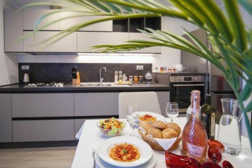 a kitchen with a table with food and wine bottles at La Terrazza di Andrea in Imperia