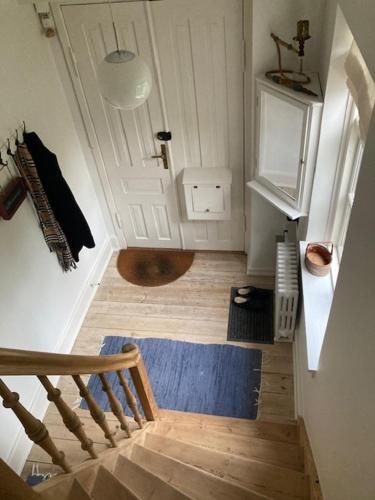 a staircase leading to a bathroom with a white door at 1st floor 2 rooms with kitchenette in Store Heddinge