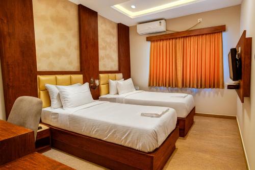 Postel nebo postele na pokoji v ubytování Stayz Royale Koromangala