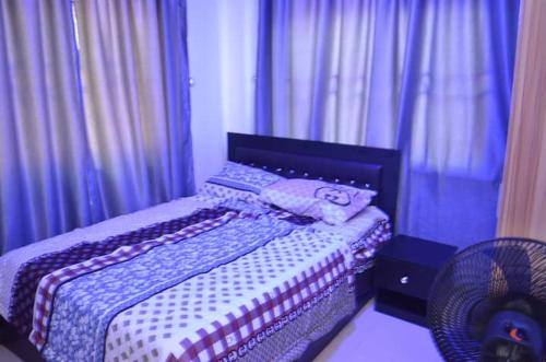 a bedroom with a bed with a teddy bear on it at Metroluxe in Akure