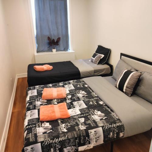 a bedroom with two beds and a window at Sweet Home in Bloor Downtown-CENTRAL STAY in Toronto
