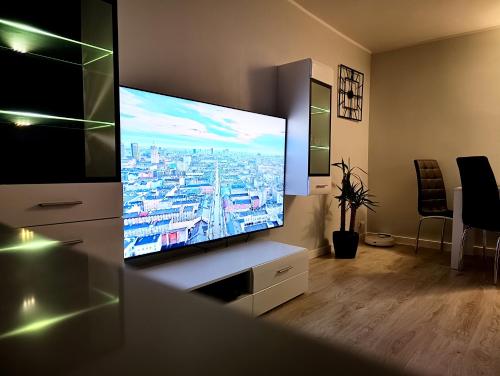 a living room with a large flat screen tv at Gdańsk - Quiet area with a sea view in Gdańsk