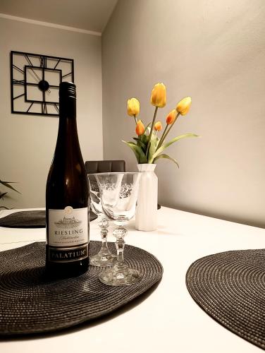 a bottle of wine sitting on a table with a glass at Gdańsk - Quiet area with a sea view in Gdańsk