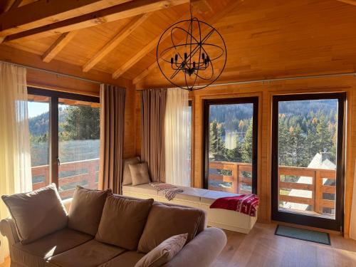 a living room with a couch and a large window at Alpenzeit Lachtal in Lachtal