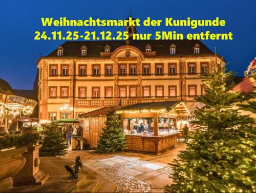 a large building with a christmas tree in front of it at Holiday il Macellaio - NW Zentrum - X-MAS Markt 5min entfernt in Neustadt an der Weinstraße