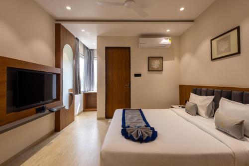 Ένα ή περισσότερα κρεβάτια σε δωμάτιο στο Pravasa Stay, Bapat Square