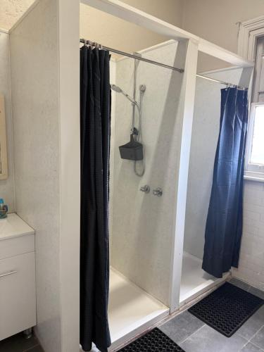 a shower with a glass door in a bathroom at Jerilderie Hotel in Jerilderie