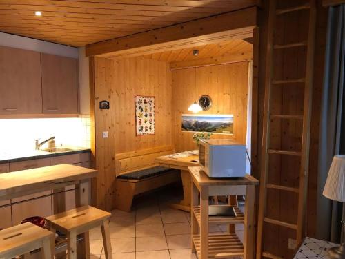 a room with a kitchen with a table and a stove at Haus Pollux in Hasliberg