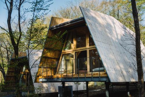 a tree house with a glass facade at SANU 2nd Home 那須2nd in Nasu