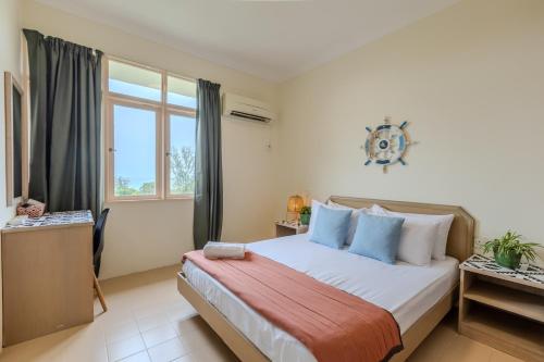 a bedroom with a large bed and a window at EE's Summer House - Homestay 3 min walk to beach in Batu Ferringhi