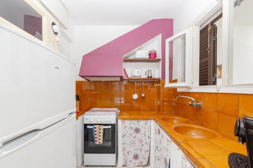 a small kitchen with a sink and a microwave at Apto Familiar frente a cala in Cala en Forcat