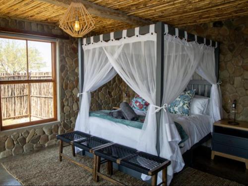 a bedroom with a bed with a canopy at Elandskop in Breede River DC