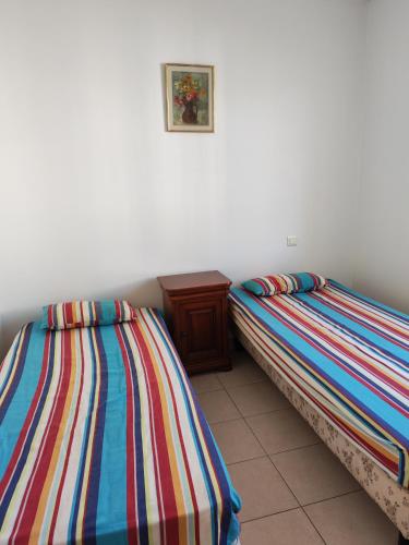 two beds sitting next to each other in a room at Casa Helena in Saint-Florent