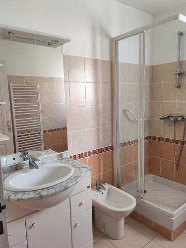 a bathroom with a sink and a shower and a toilet at Casa Helena in Saint-Florent