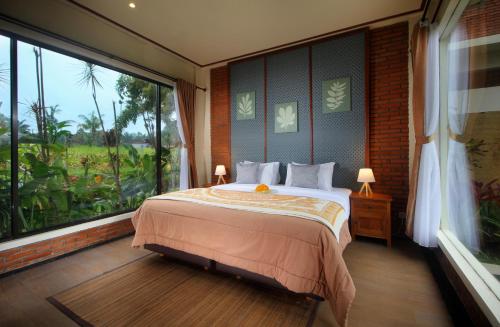 a bedroom with a bed and a large window at 2 Bedrooms Private Pool Villa Tegalalang-Ubud in Tegalalang