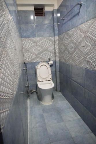 a bathroom with a toilet with the lid up at Khangsar Home in Kathmandu