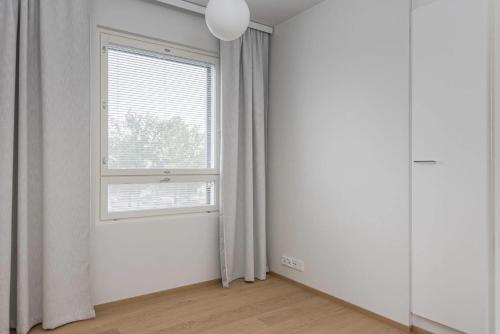 a room with a window and a white wall at Porvoo Sibelius - Free WiFi in Porvoo