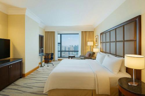 a hotel room with a large bed and a television at The Westin Dhaka in Dhaka