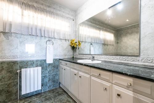 ein Badezimmer mit Waschbecken und Spiegel in der Unterkunft Villa GOLETA in Ferrán