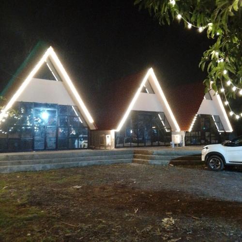 a building with lights on it at night at Rustic Palms in Thāl