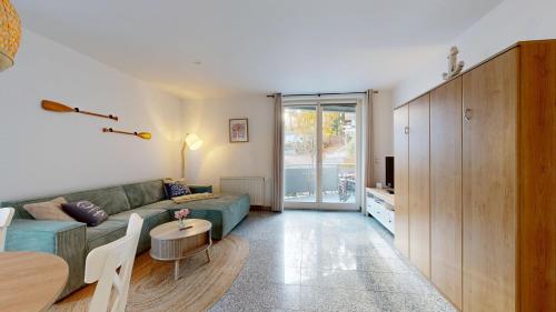 a living room with a couch and a table at strandnahe FeWo mit Schwimmbad im Haus, a cappella 68,Binz in Binz