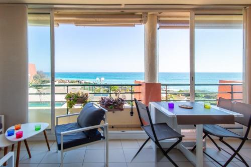 a dining room with a view of the ocean at Terramer – Séjour face à la mer, Wifi, plage, piscine et commerces à pied - Corniche in Sète