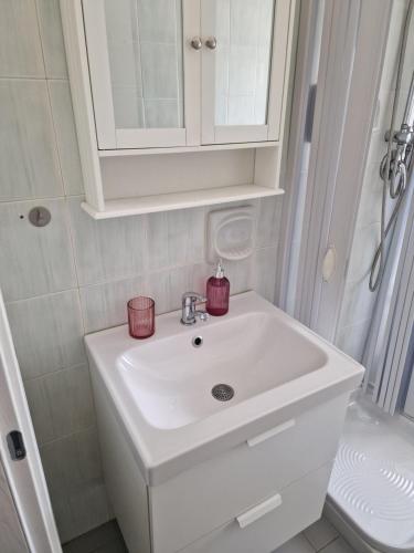 a bathroom with a white sink and a shower at Casa Gemma in Padova