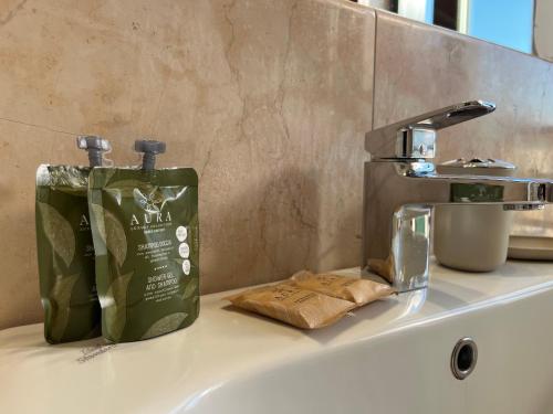 a green bottle of soap sitting on top of a sink at Teentori in Camposampiero