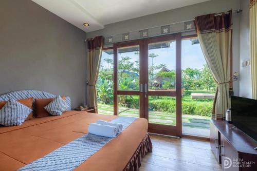 Postel nebo postele na pokoji v ubytování Jawa Dwipa Villa