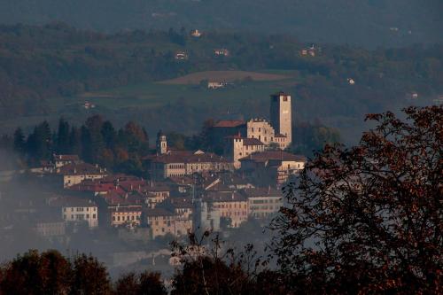 a town on top of a hill with buildings at Mini Viale Farra in Feltre