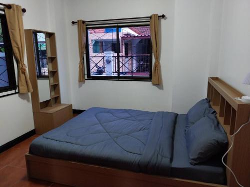 a bedroom with a bed and a window at House in the heart of Kamala in Kamala Beach