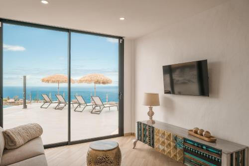 a living room with a view of the ocean at Finca el Moral by Huskalia in Los Llanos de Aridane