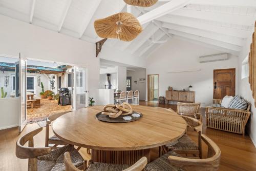 a dining room with a wooden table and chairs at Saltwood Walk to Yallingup Lagoon in Yallingup