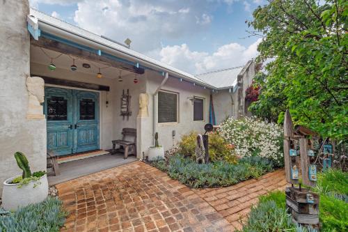 a house with a blue door and a brick driveway at Saltwood Walk to Yallingup Lagoon in Yallingup