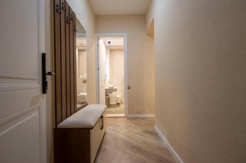 a hallway with a bathroom with a sink and a door at Kinor David Glatt Kosher Hotel in Tbilisi City