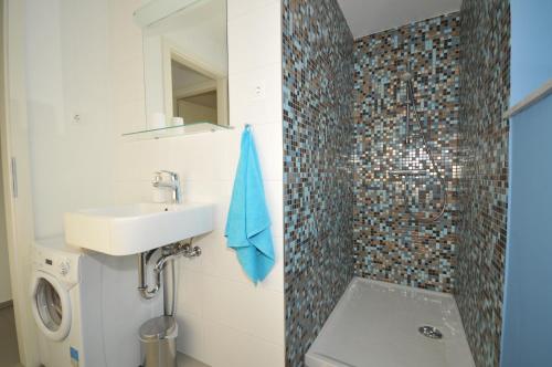 een badkamer met een wastafel en een douche bij Atrium flat in the Villa in Ljubljana