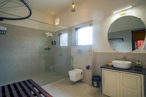 um banheiro com um vaso sanitário, uma pia e um espelho em Garrison at Dera Bagseu em Bikaner