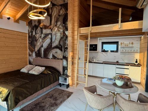 a bedroom with a bed and a table with chairs at Bükk Hill Garden in Miskolc