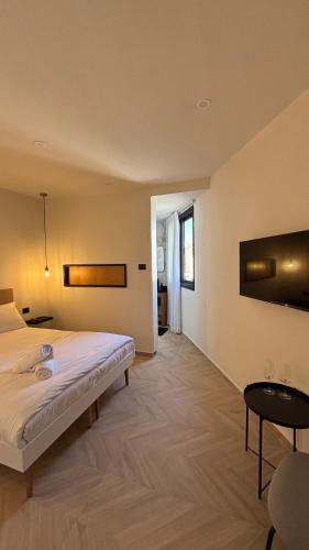 a bedroom with a large bed and a table at RASHI6 Boutique Villa in Netanya
