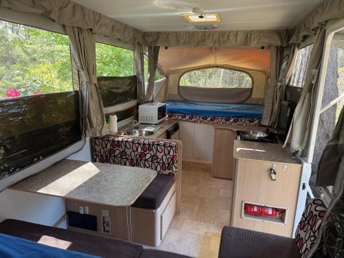 an interior view of an rv with a kitchen and a sink at Onsite van in Medlow Bath in Medlow Bath