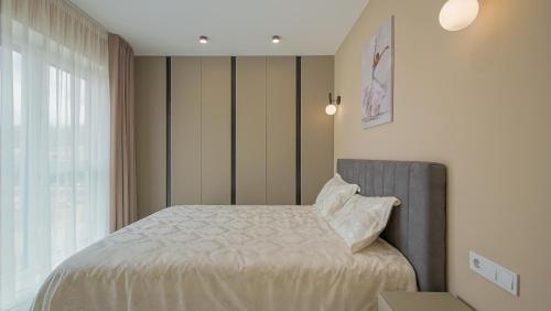 a bedroom with a bed and a window at Le Luna Apart in Braşov