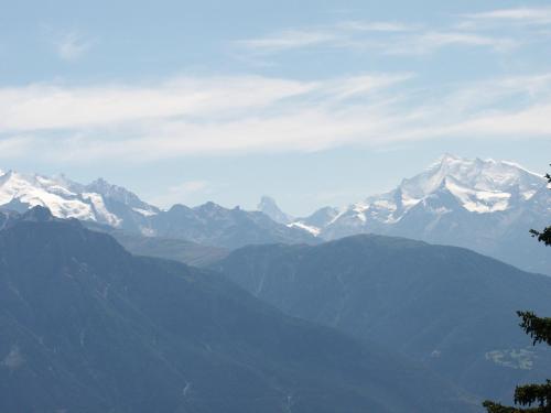 a view of a mountain range with snow capped mountains at Chalet Foresta in Bettmeralp