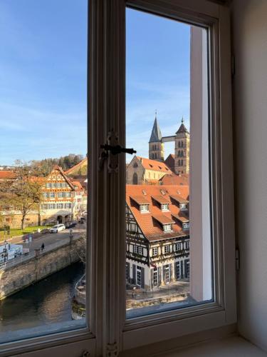 a window with a view of a city at MAVO Hospitality Esslingen Bahnhofstraße in Esslingen
