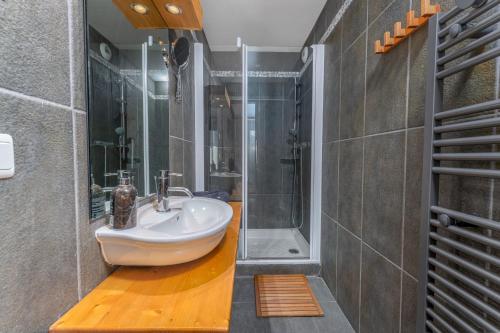 ein Badezimmer mit Waschbecken und Dusche in der Unterkunft Appartements de la Chamoissière in Le Monêtier-les-Bains