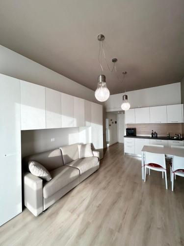 a living room with a couch and a table at Rucola Home in Castione della Presolana