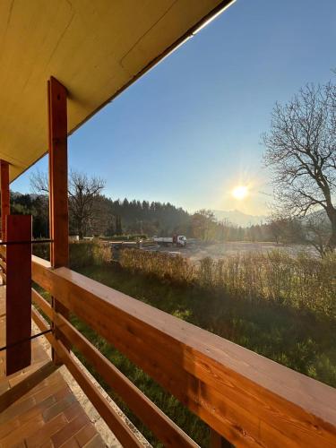 a view of a field from the porch of a house at Rucola Home in Castione della Presolana